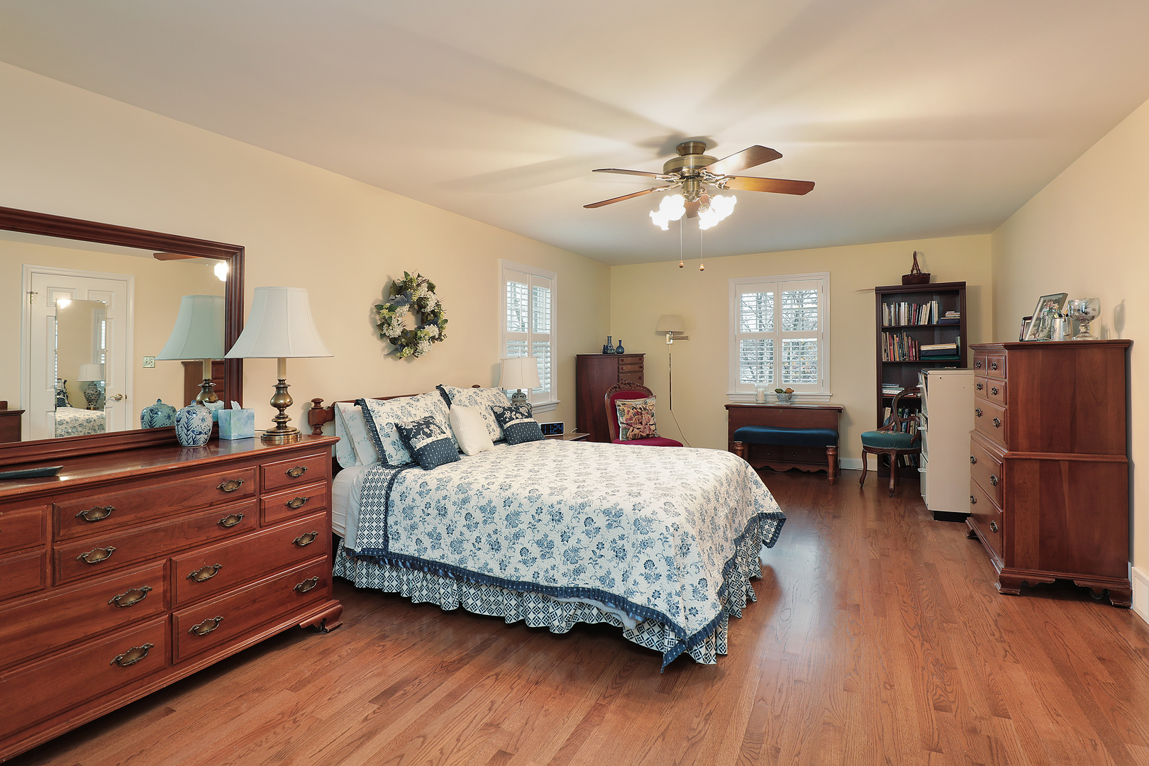 1211 Norman Lane Deerfield, IL 60015 - Photo 7 of 17 a bedroom with a large bed and a chandelier