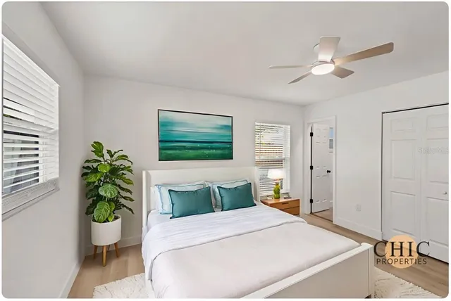 a bedroom with a bed and a potted plant