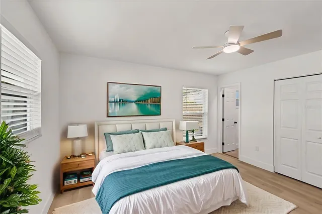 a bedroom with a bed and a painting on the wall