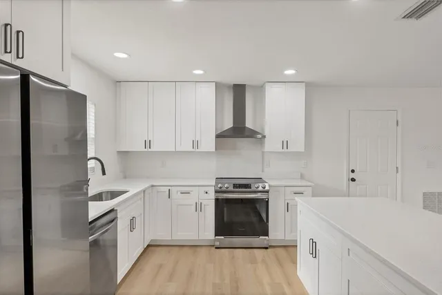 a kitchen with a sink a stove and refrigerator