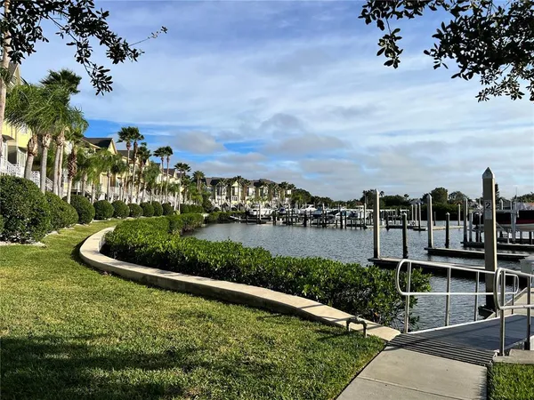 a view of a multi story residential apartment building with a yard and outdoor seating