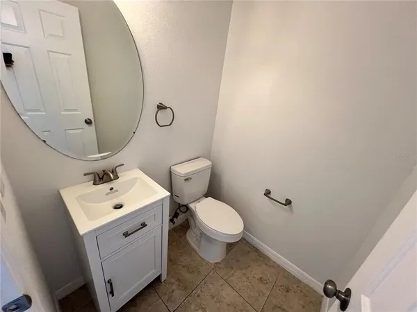 a bathroom with a sink toilet and mirror