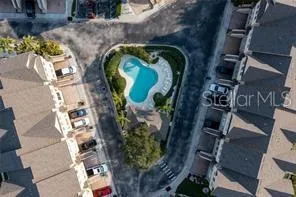 an aerial view of residential houses with outdoor space and river