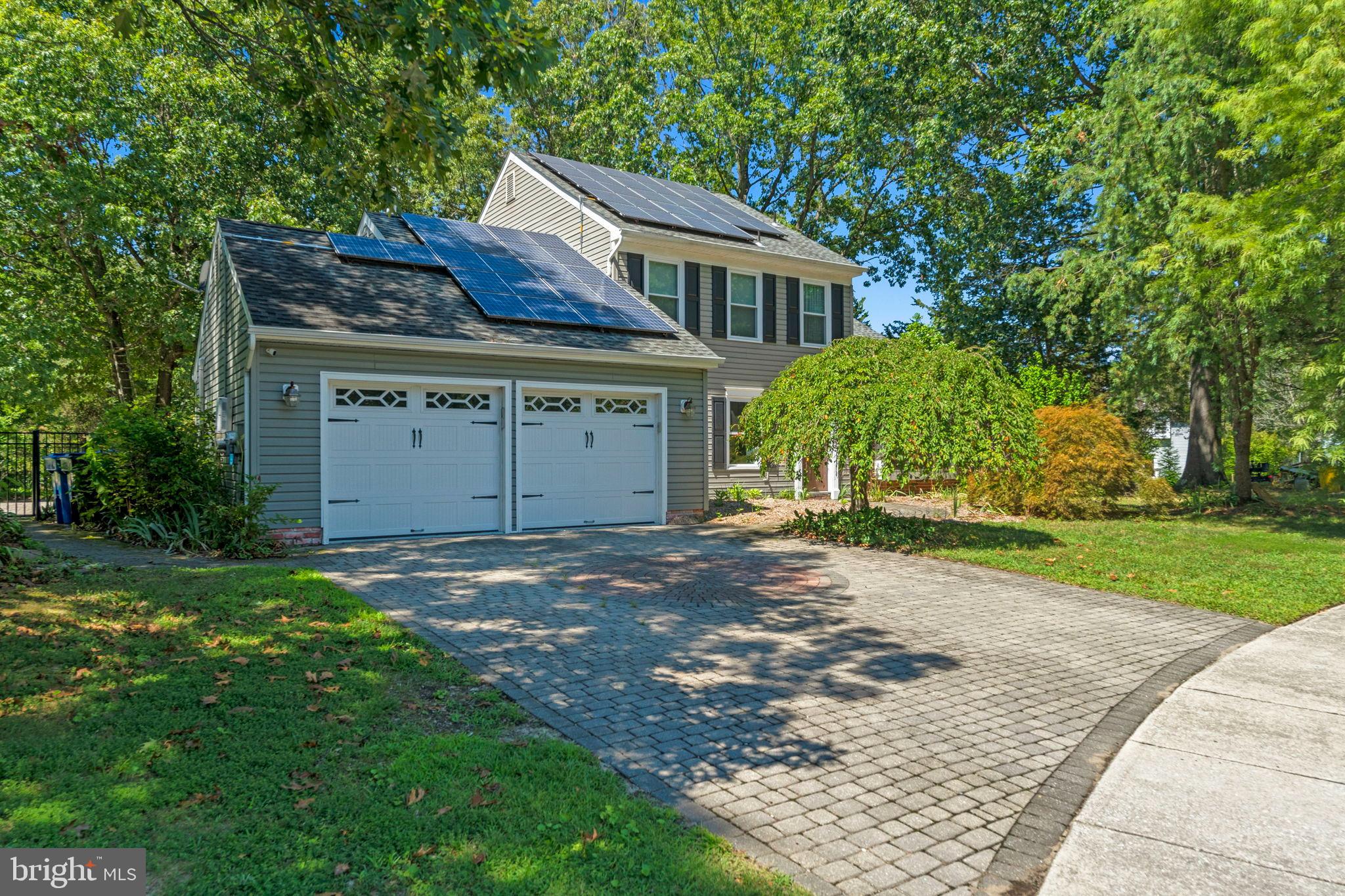 3 Spring Lake Court Sewell, NJ 08080 - Photo 2 of 36 Charming home with solar panels and lush greenery.