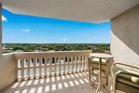 a view of a chairs and table in the roof deck