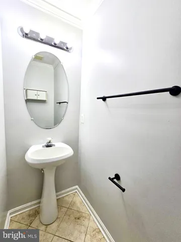 a bathroom with a sink toilet and mirror
