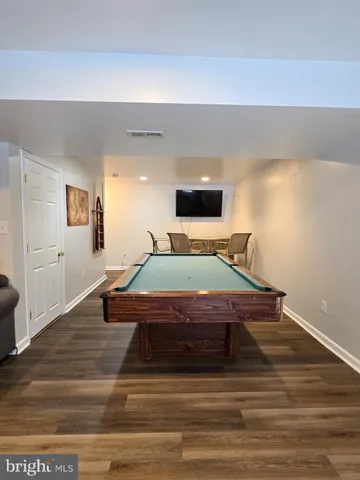 a room with pool table and windows