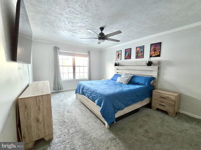 a spacious bedroom with a bed and a window