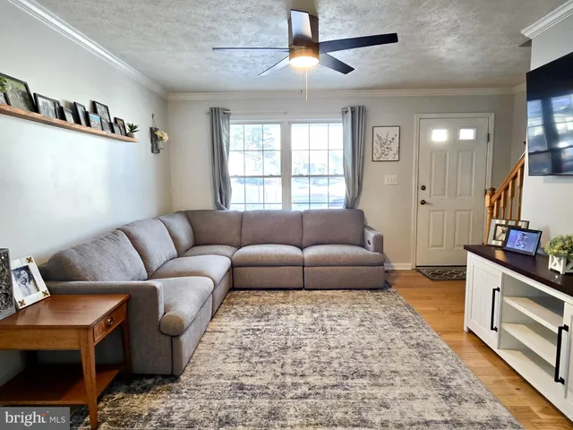 a living room with furniture and a rug