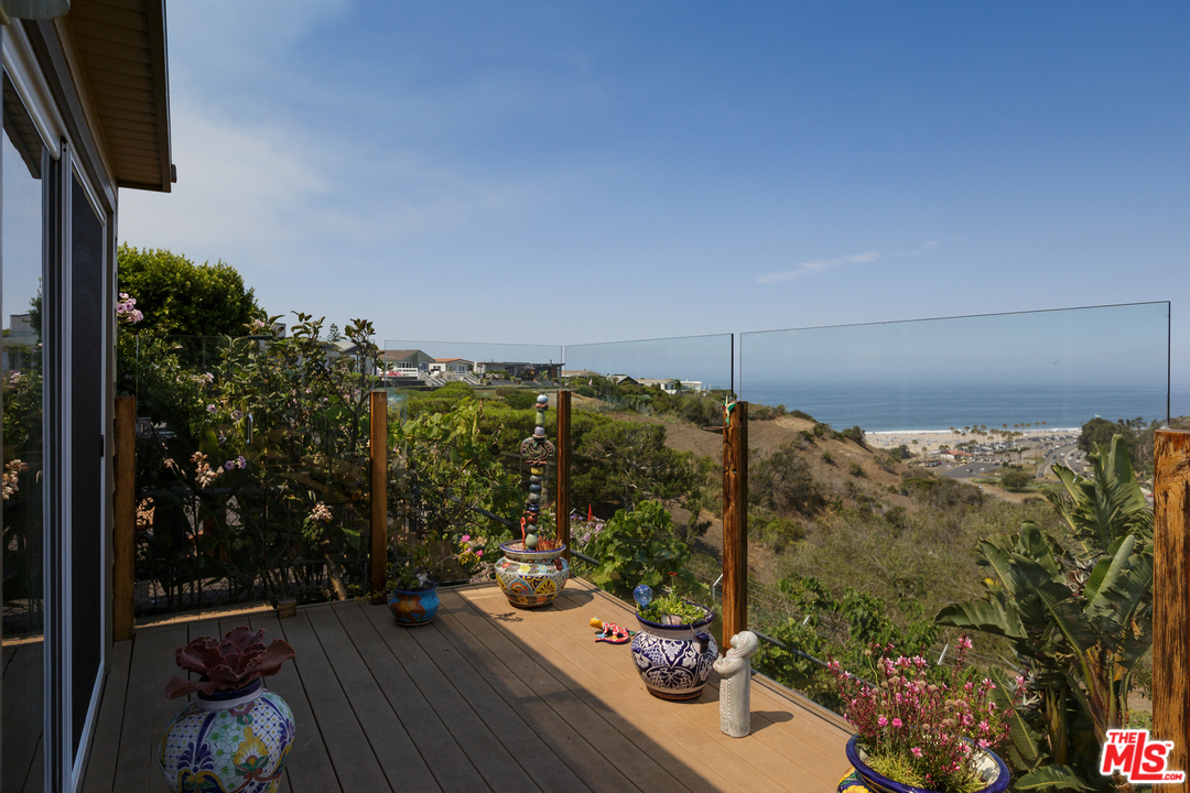 a view of a balcony with chair and table in the balcony