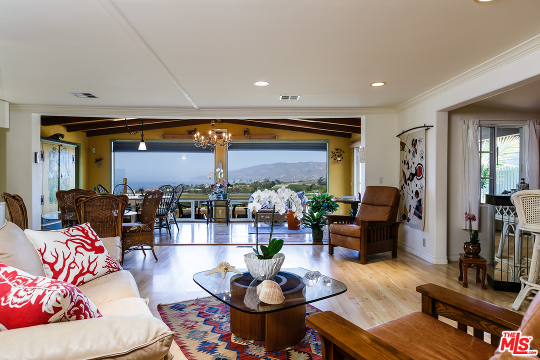 29500 Heathercliff Road, Unit 202 Malibu, CA 90265 - Photo 11 of 30 a living room with furniture potted plant and kitchen view