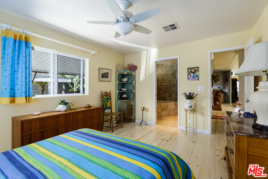 29500 Heathercliff Road, Unit 202 Malibu, CA 90265 - Photo 19 of 30 a room that has a bed and a table in it