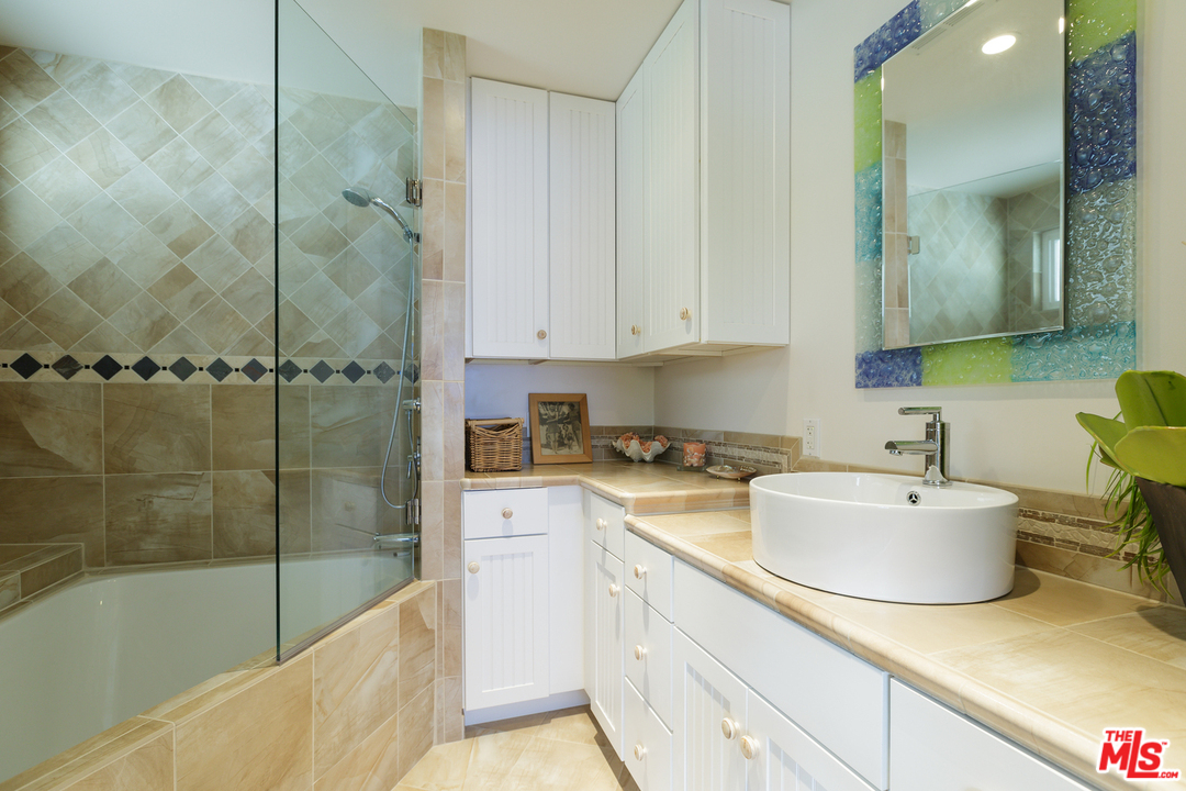 29500 Heathercliff Road, Unit 202 Malibu, CA 90265 - Photo 20 of 30 a bathroom with a sink and a mirror
