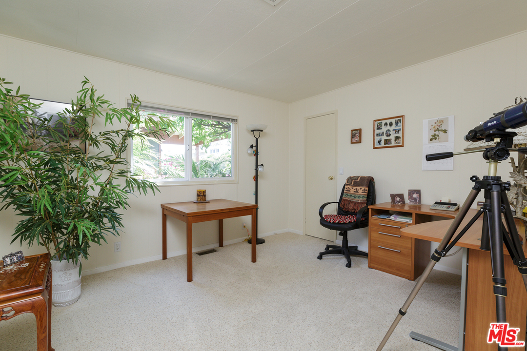 29500 Heathercliff Road, Unit 202 Malibu, CA 90265 - Photo 21 of 30 a living room with furniture a window and a potted plant