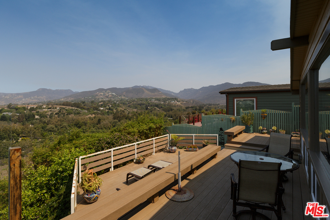 29500 Heathercliff Road, Unit 202 Malibu, CA 90265 - Photo 5 of 30 a view of a balcony with mountain view and wooden floor