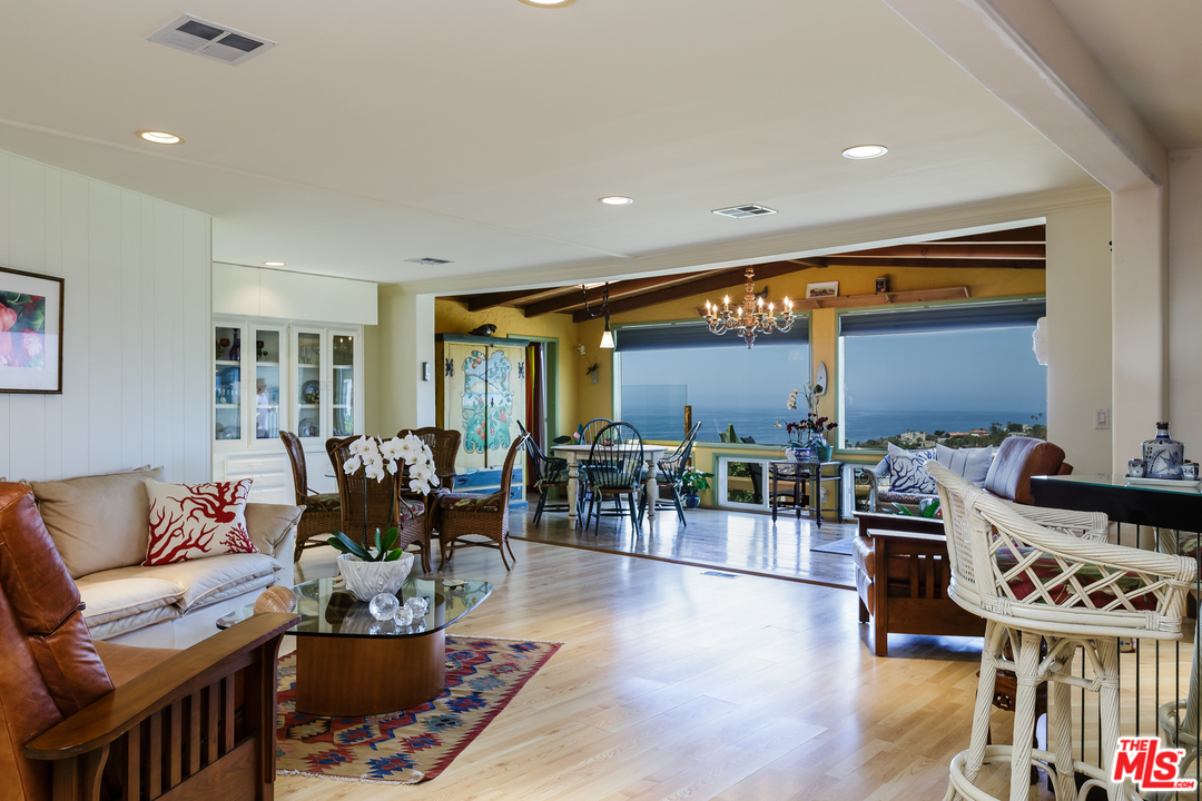 29500 Heathercliff Road, Unit 202 Malibu, CA 90265 - Photo 7 of 30 a living room with furniture a wooden floor and next to a window