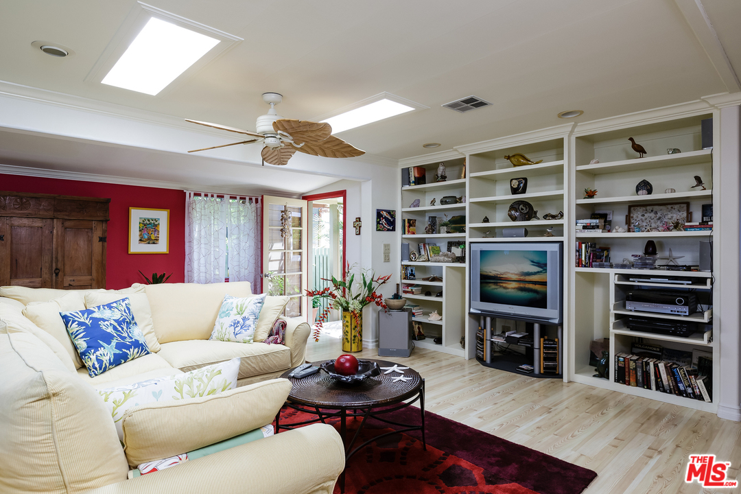 29500 Heathercliff Road, Unit 202 Malibu, CA 90265 - Photo 8 of 30 a living room with furniture and a book shelf