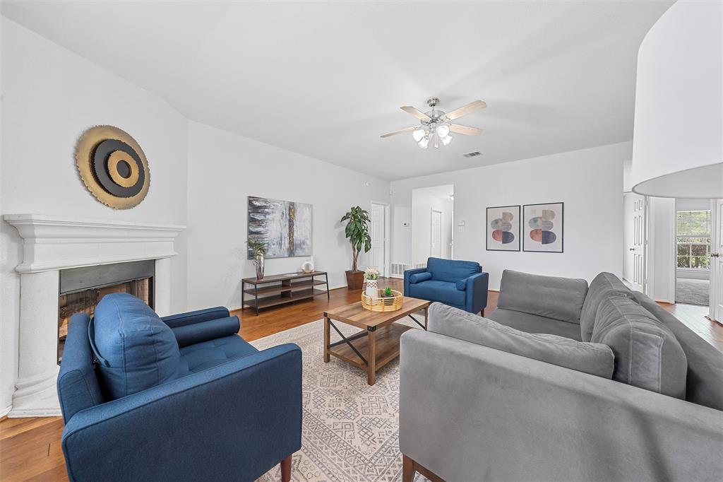 10120 Salem Way Waco, TX 76708 - Photo 5 of 19 Living area featuring wood finished floors, a fireplace, and ceiling fan