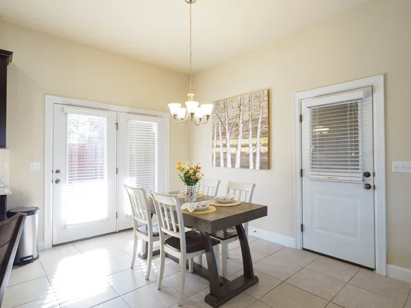 a large kitchen with a table and chairs