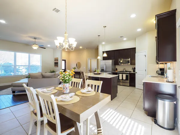a kitchen with stainless steel appliances kitchen island granite countertop a sink counter space and cabinets