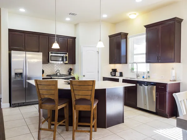 a kitchen with a sink a counter top space appliances and cabinets