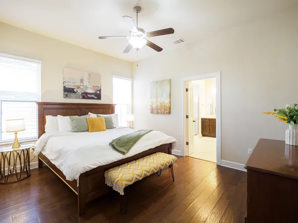 a bedroom with a bed and wooden floor