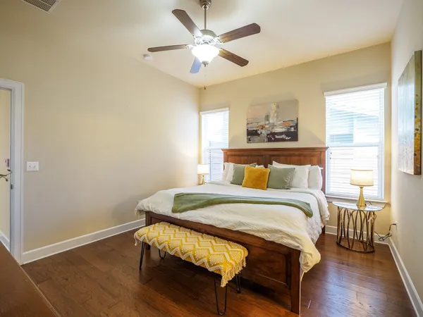 a bedroom with a bed and wooden floor