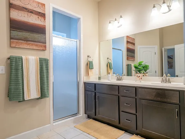 a bathroom with a double vanity sink and a mirror