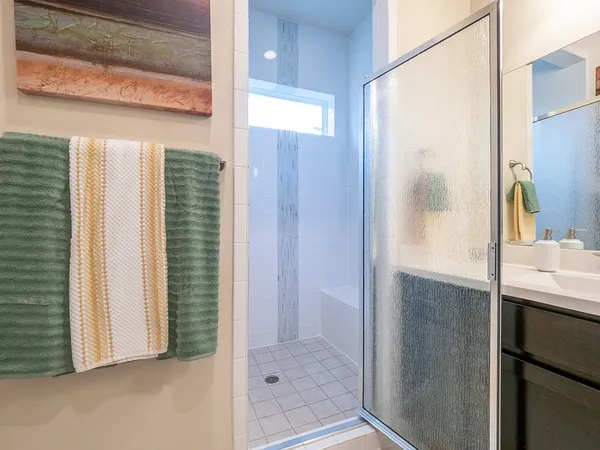 a bathroom with a shower and a sink