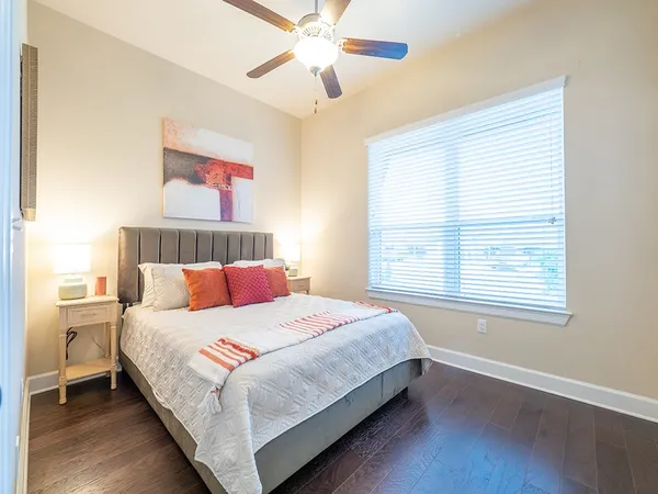 a bedroom with a bed and a window