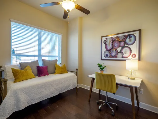 a bedroom with a bed and a chandelier