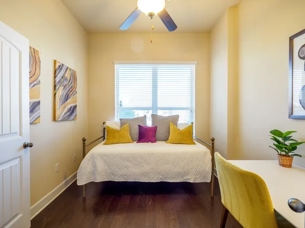 a bedroom with a bed and wooden floor