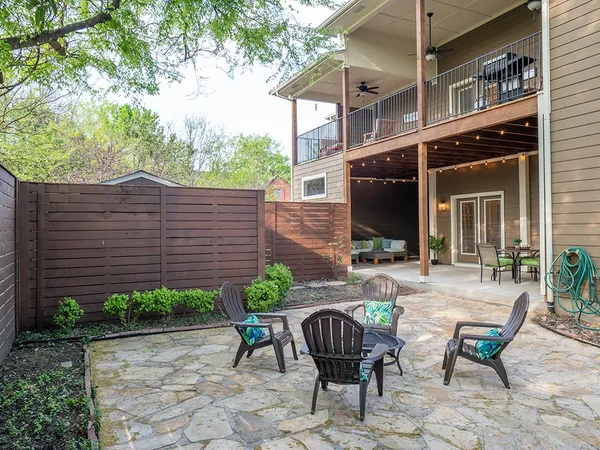 a view of a patio with table and chairs and potted plants