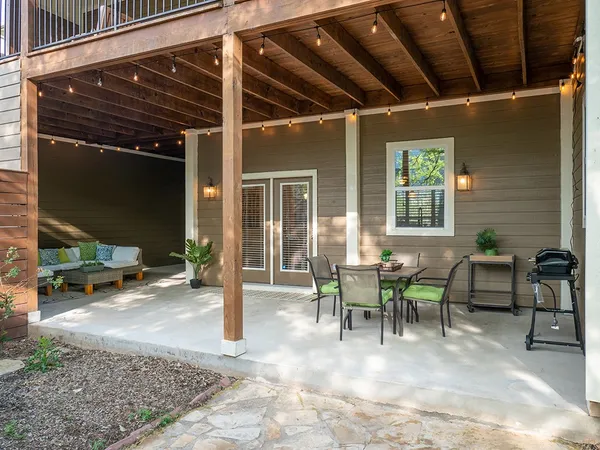 a view of a patio with table and chairs