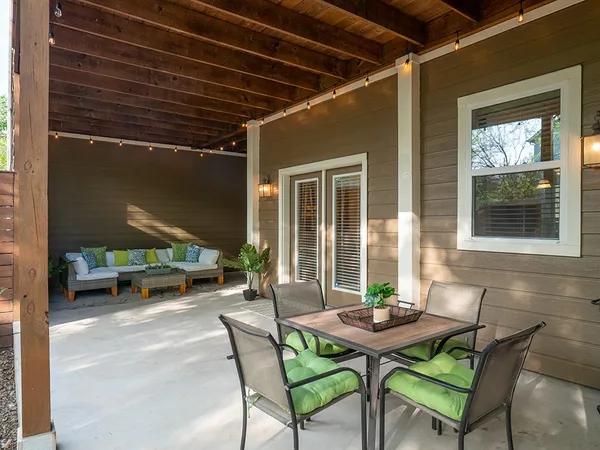 a view of a patio with a table and chairs