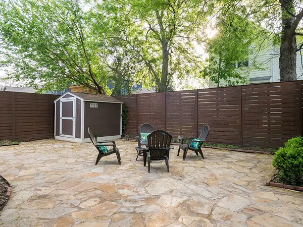 a backyard of a house with table and chairs