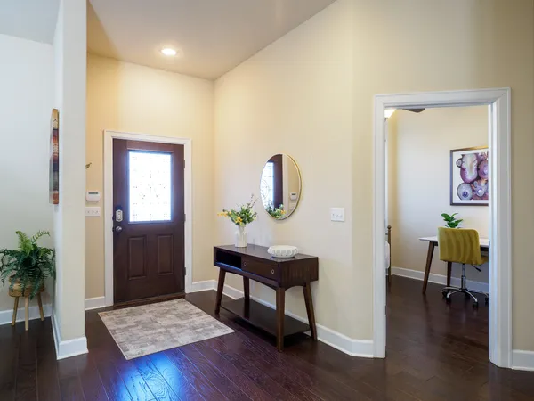 a living room with furniture kitchen view and a large window