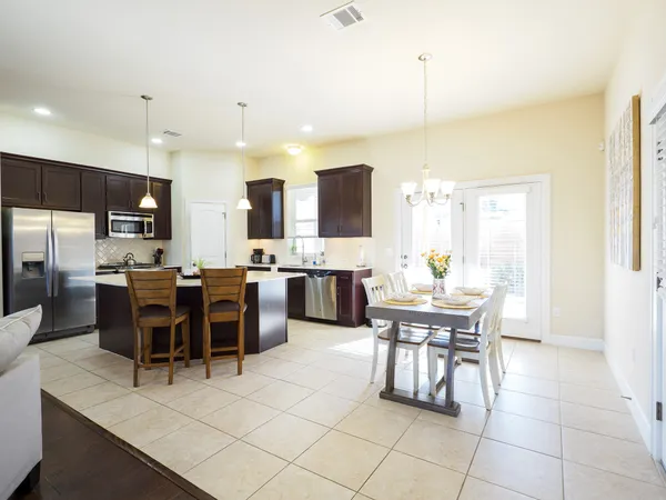 a view of a dining room with furniture and chandelier