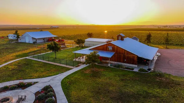 an aerial view of residential houses with outdoor space and ocean