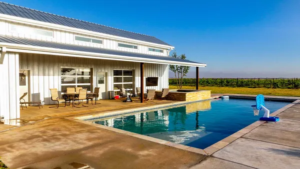 a view of a patio with swimming pool table and chairs