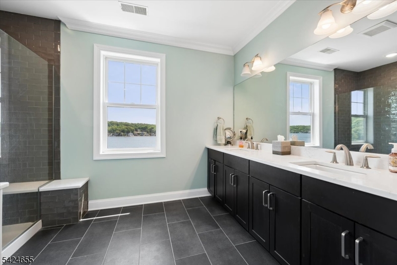 401 Mariners Pointe Hopatcong, NJ 07843 - Photo 28 of 42 a bathroom with a double vanity sink a toilet and a mirror