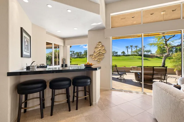 a view of a dining room with furniture large windows and wooden floor