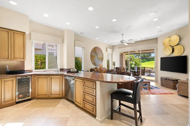 a spacious bedroom with a bed and a flat screen tv