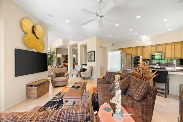 a bathroom with a granite countertop sink two mirror and a window