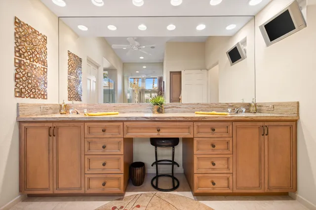 a bathroom with a granite countertop sink toilet and mirror