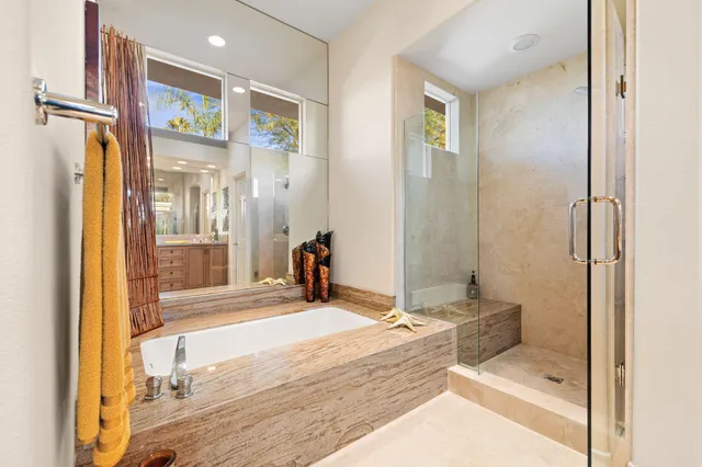 a front view of a house with swimming pool having outdoor seating