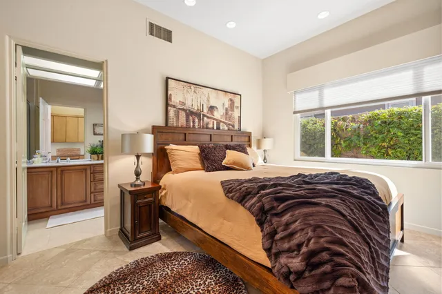a view of a patio with couches table and chairs and potted plants