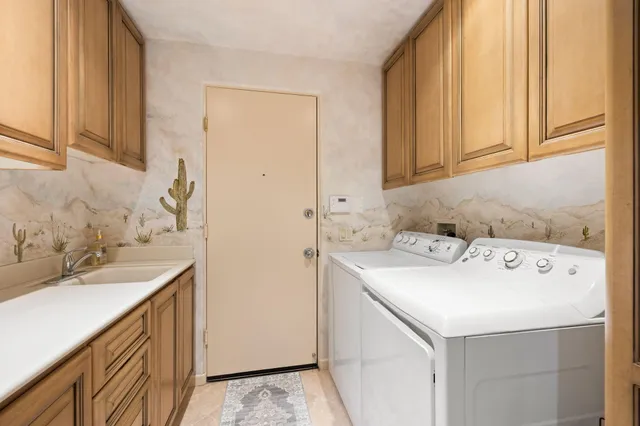 a view of a city with lots of residential buildings ocean and mountain view in back