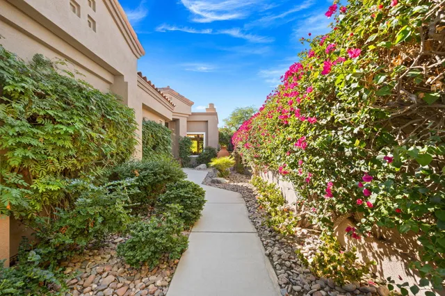 a living room with furniture a fireplace and a large window
