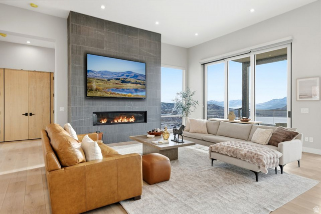 2002 East Outlaw Road Kamas, UT 84036 - Photo 23 of 65 Expansive living area with a stone-look fireplace surround, linear gas fireplace, and large sliding glass doors